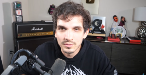 Nik Nocturnal recording a reaction video in his studio.